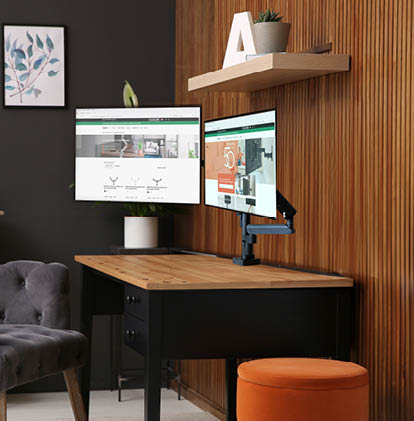 Comfortable workplace with computer near wooden wall in stylish room interior. Home office design